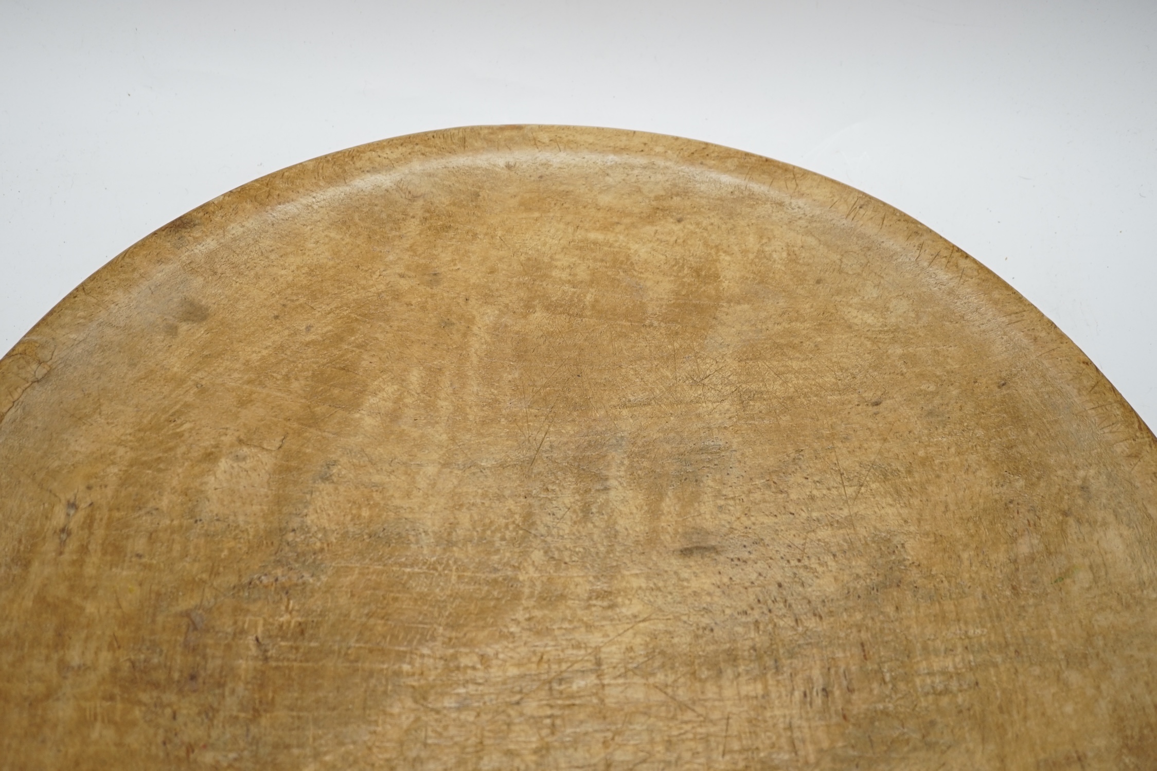 A large turned beech bowl of shallow form, 45cm in diameter
